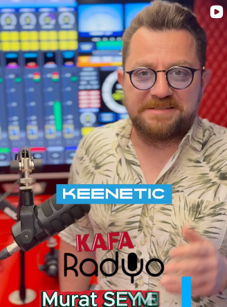 a man wearing headphones and sitting in front of a microphone